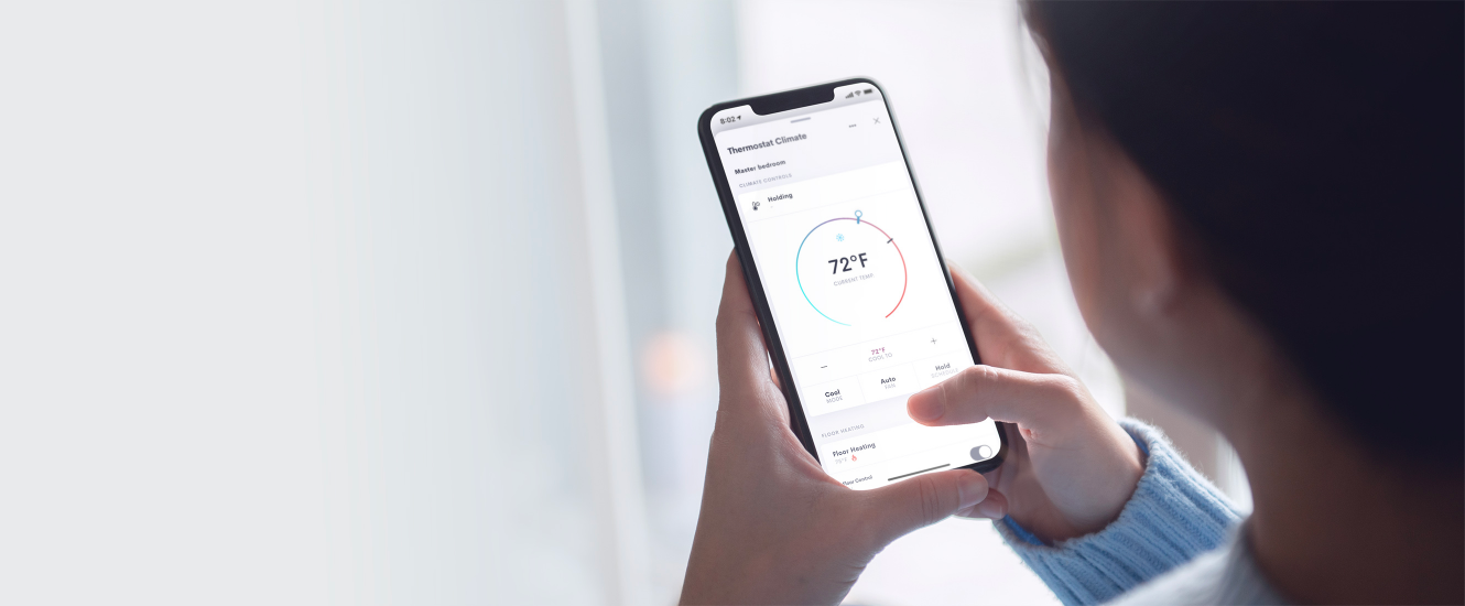 Control4 Touch panel in a able with a traditional home in the background